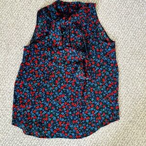 Silky tie neck sleeveless shirt in vibrant blue and red flower print